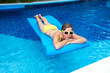Photo: Woman in swimming pool at caribbean resort. Woman in swimming pool at caribbean resort.