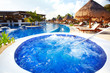 Jacuzzi and a swimming pool at caribbean resort.