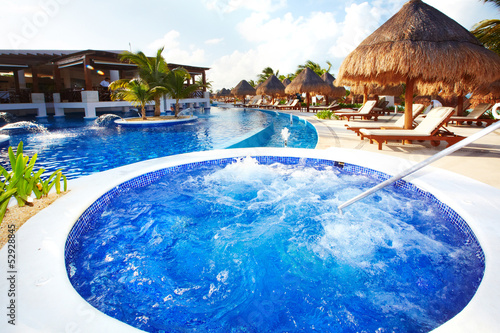 Photo: Jacuzzi and a swimming pool at caribbean resort. Jacuzzi and a swimming pool at caribbean resort.