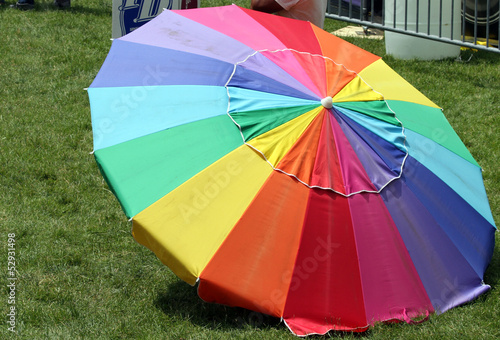 Photo: A Rainbow-Colored Parasol on green grass A Rainbow-Colored Parasol on green grass