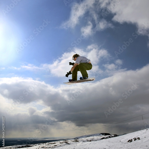 Photo: Snowboarder jumping in mountains Snowboarder jumping in mountains