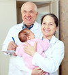 mature doctor and nurse with baby