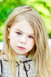Beautiful blond crying little girl with tears on her cheeks
