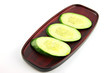 Cucumber slices placed in a dish.