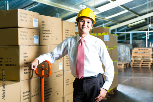 Photo: Young Man in warehouse he is a manager Young Man in warehouse he is a manager