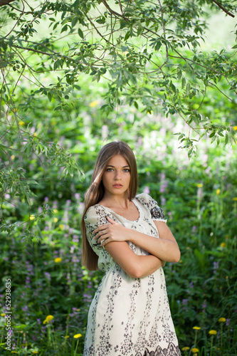 Photo: Beautiful girl among the meadow flowers Beautiful girl among the meadow flowers