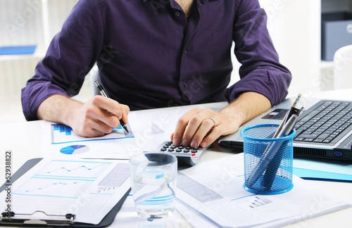 Photo: business man analyzing financial data business man analyzing financial data