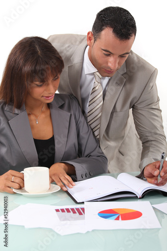 Photo: Man and woman interpreting financial results Man and woman interpreting financial results
