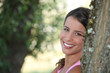 Girl relaxing under tree