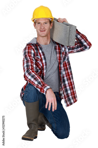 Photo: Mason resting breeze block on shoulder Mason resting breeze block on shoulder