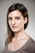 Portrait of a normal young woman on a grey background