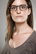 Portrait of a normal young woman on a grey background