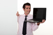 Man in smart suit showing notebook