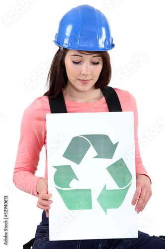 Photo: Tradeswoman holding a recycling sign Tradeswoman holding a recycling sign