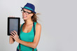 Photo: Funny trendy girl showing tablet screen Funny trendy girl showing tablet screen