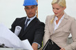 Photo: Architects discussing plans on site Architects discussing plans on site