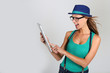 Girl with hat websurfing with tablet