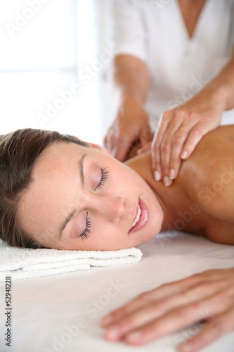 Photo: Beautiful girl receiving oil massage in beauty salon Beautiful girl receiving oil massage in beauty salon