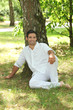 Photo: Man sitting under a tree Man sitting under a tree