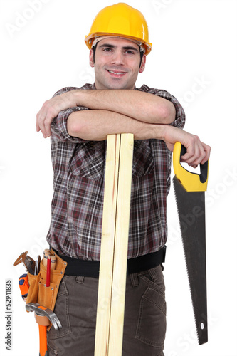 Photo: Carpenter with wood slats and saw Carpenter with wood slats and saw