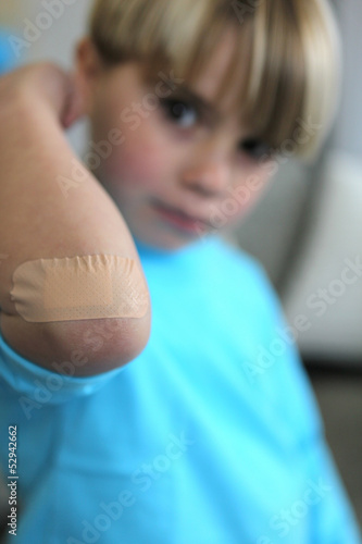 Photo: Little boy with plaster on his elbow Little boy with plaster on his elbow
