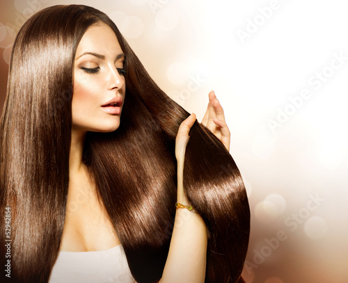 Photo: Beauty Woman touching her Long and Healthy Brown Hair Beauty Woman touching her Long and Healthy Brown Hair