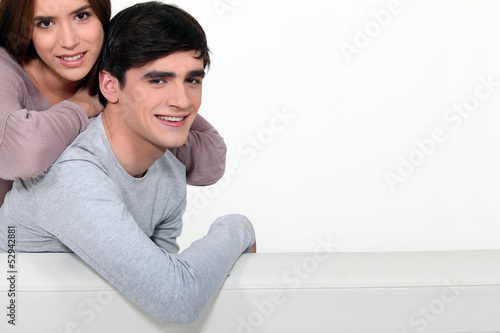 Photo: Couple stood with blank poster Couple stood with blank poster