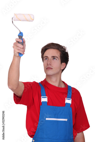 Photo: Man using paint roller Man using paint roller