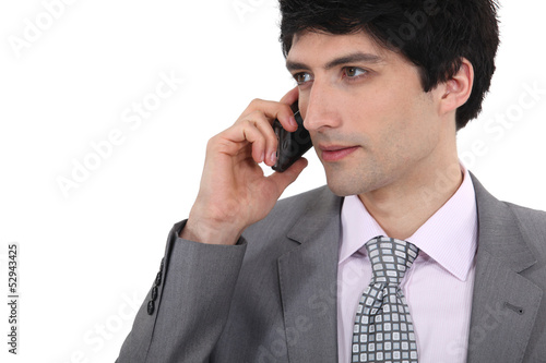 Photo: Businessman taking a call on his mobile Businessman taking a call on his mobile