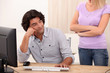 Photo: Woman peeved at her partner's computer use Woman peeved at her partner's computer use