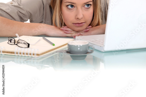Photo: Woman peering at her laptop Woman peering at her laptop