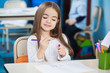 Girl Looking At Sketch Pen In Classroom