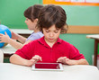 Photo: Boy Using Digital Tablet At Desk Boy Using Digital Tablet At Desk
