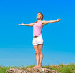 Beautiful athletic girl standing on the stone in the morning