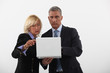 Photo: businessman and businesswoman holding a laptop businessman and businesswoman holding a laptop