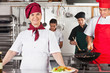 Confident Female Chef In Kitchen