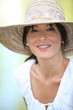 Photo: 30 years old brunette wearing a straw hat and a summer dress 30 years old brunette wearing a straw hat and a summer dress