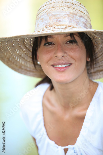 Photo: 30 years old brunette wearing a straw hat and a summer dress 30 years old brunette wearing a straw hat and a summer dress