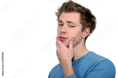 Photo: Man with his hand on chin Man with his hand on chin