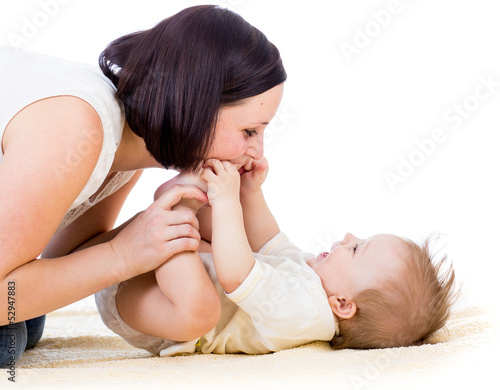 Photo: happy mother having fun with her baby boy infant happy mother having fun with her baby boy infant