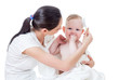 mother combing baby after bathing