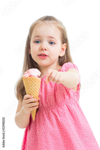 Photo: joyful child girl eating ice cream in studio isolated joyful child girl eating ice cream in studio isolated