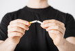 man breaking the cigarette with hands