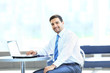 Photo: Portrait of busy manager typing on the laptop in the office Portrait of busy manager typing on the laptop in the office