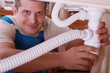 Foto: Plumber fitting a kitchen sink Plumber fitting a kitchen sink