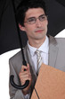 Businessman with folder sheltering from rain