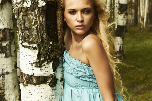 Photo: Beautiful blond woman in forest. flying hair Beautiful blond woman in forest. flying hair