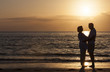 Photo: Happy Senior Couple Embracing on Sunset Beach Happy Senior Couple Embracing on Sunset Beach