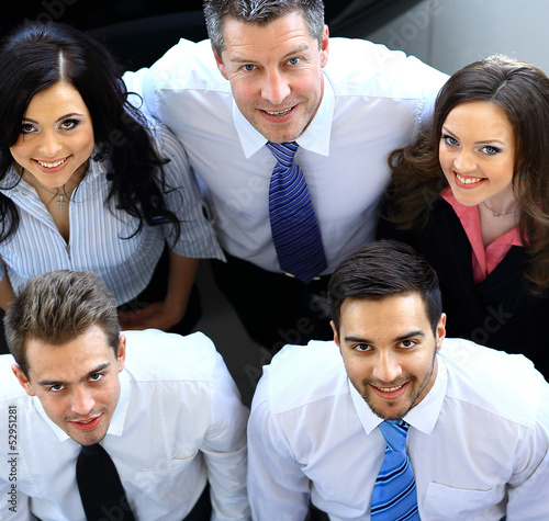 Photo: Portrait of smiling business people. Top view Portrait of smiling business people. Top view