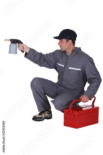 Photo: Workman with a blowtorch Workman with a blowtorch